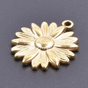 Close-up of a polished golden sunflower pendant with detailed textured petals on dark background