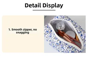 Detail view of the floral makeup bag showing smooth zipper and spacious cotton interior