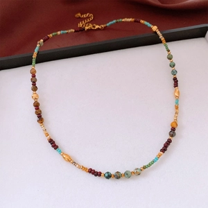 Detailed view of vintage zircon rotating flower pendant necklace with colorful beads