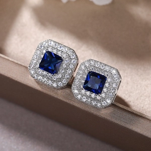 Macro view of square blue sapphire earrings with double halo zircon stones setting
