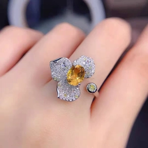 Luxurious adjustable floral ring featuring a yellow gemstone and micro-paved petals