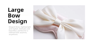 Close-up of a pink silk sleep mask featuring a large decorative white bow detail