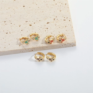 Golden Hamsa hand huggie earrings with colorful enamel devil's eye and white zircon