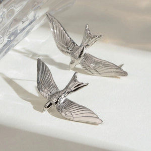 Silver stainless steel swallow bird stud earrings in a minimalist and vintage aesthetic
