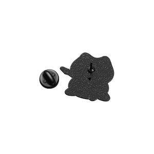 Detail view of the black matte metal back with rubber pin clutch for a character badge