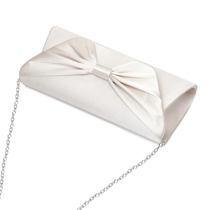 Close-up of elegant cream white satin evening clutch bag with bow and silver chain strap