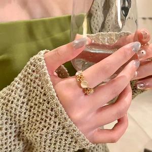 French vintage gold hollow coin ring with resin inlay worn on hand with sweater