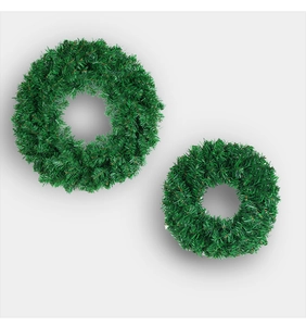Top view of two artificial green Christmas wreaths in different sizes on grey background