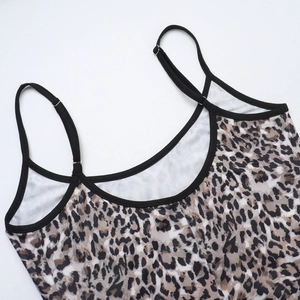 Detail of adjustable black shoulder straps and leopard print fabric on a maxi dress