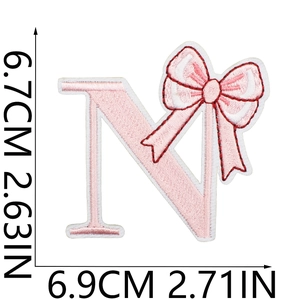 Detail view of pink bow embroidered letter N patch with exact size measurements