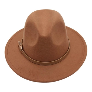 Close-up of caramel wool fedora hat featuring a stylish leather band and golden buckle