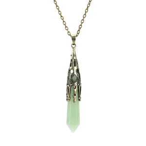 Detail of light green hexagonal crystal pendant with antique bronze floral metal cap