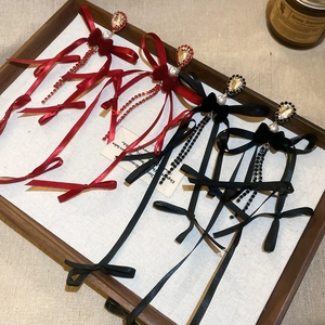 Boucles d'oreilles élégantes nœud pompon perle en rouge et noir avec strass sur plateau