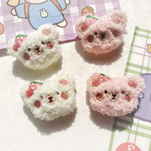 Detailed embroidery of cute plush bear patches with strawberry accents for bags