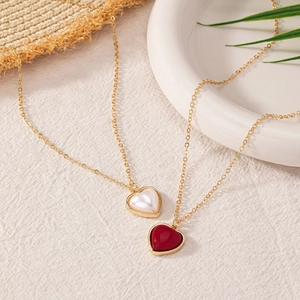Minimalist gold heart pendant necklaces set in white pearl and deep red enamel finish
