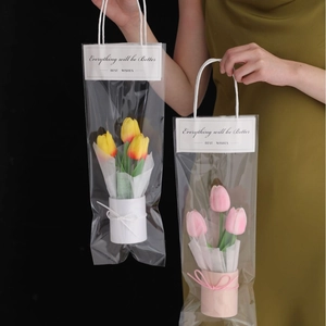 Handheld gift bags with yellow and pink PU tulips in cylindrical pots for gifting