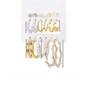 Detailed view of 9-pair gold butterfly and pearl earring set with precise size measurements