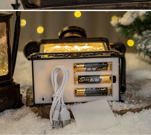 Detail of vintage Christmas lantern base showing dual USB and battery power options