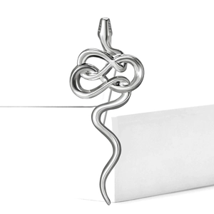 Macro shot of silver metal snake brooch with a polished finish for suit lapels