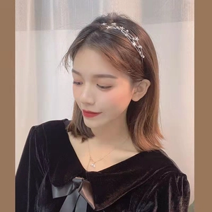 Elegant double-layered silver star headband for women on fashion model with warm background