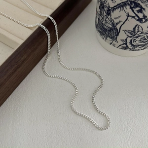 Minimalist 925 sterling silver curb chain necklace styled with an elegant ceramic cup