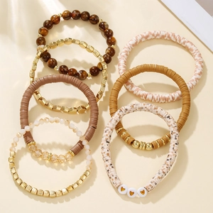 Detailed close-up of 7-piece bohemian stackable bracelets with gold heart charms