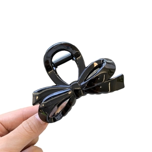 Glossy black butterfly hair claw clip with irregular design for versatile hairstyles