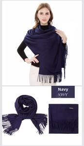 Close-up of navy blue cashmere scarf showing soft texture and fine fringe details