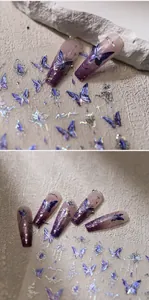 Detailed close-up of purple butterfly nail stickers with holographic silver star accents