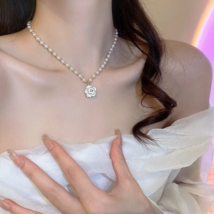 Elegant pearl necklace for women featuring a white camellia flower pendant with gold edges