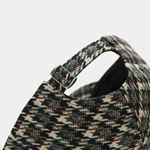 Detail of houndstooth baseball cap featuring a silver metal adjustable strap buckle