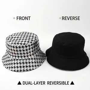Reversible houndstooth bucket hat with metallic holographic finish and black solid reverse