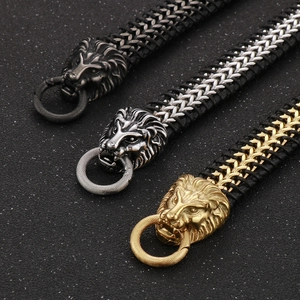 Detail of woven leather bracelets with lion head clasps in gold, silver, and antique silver