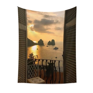 Detail of bohemian tapestry featuring a warm sunset coastal view with soft fabric folds