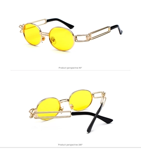 Detail of steampunk oval sunglasses with yellow lenses and hollow golden metal frames