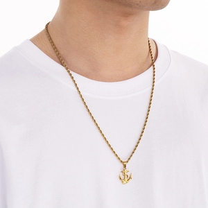 Men's gold anchor pendant necklace with rope chain on model, polished stainless steel