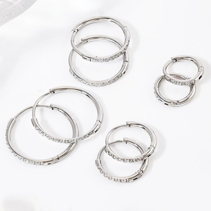 Macro view of multiple sizes of stainless steel hoop earrings with cubic zirconia inlay