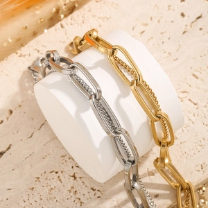 Vintage gold and silver titanium steel layered chain bracelet with textured rock backdrop