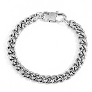 Detail of silver Cuban link bracelet featuring polished flat links and lobster clasp