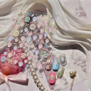 Detailed view of MS 812 nail stickers featuring gold shells, conchs and bows on silk