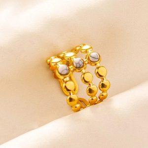 Close-up of vintage gold triple-layered ring with white marble stone inlay detail