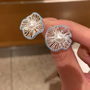 Elegant floral pearl stud earrings with blue enamel trim and silver radial textures