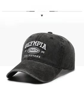 Detailed view of white athletic embroidery on a vintage washed black baseball cap