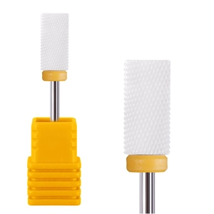 White ceramic bullet nail drill bit with yellow base showing grit texture for manicure