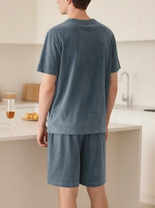 Men's blue loungewear set with soft texture in a modern home kitchen setting