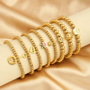 18K gold plated beaded bracelet set with cross heart and smiley pendants on silk fabric