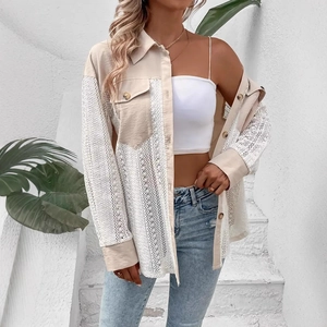 Detail of elegant lace patchwork shirt with crochet hollow sleeves and turn-down collar