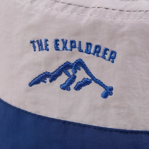 Detail of THE EXPLORER embroidery on beige and navy quick-dry nylon sun hat