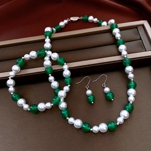 Detail shot of vintage pearl and green agate jewelry set with necklace and earrings