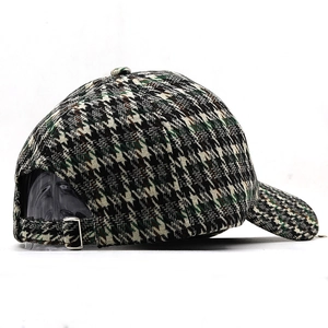 Detail of adjustable silver buckle on a thick houndstooth pattern baseball cap